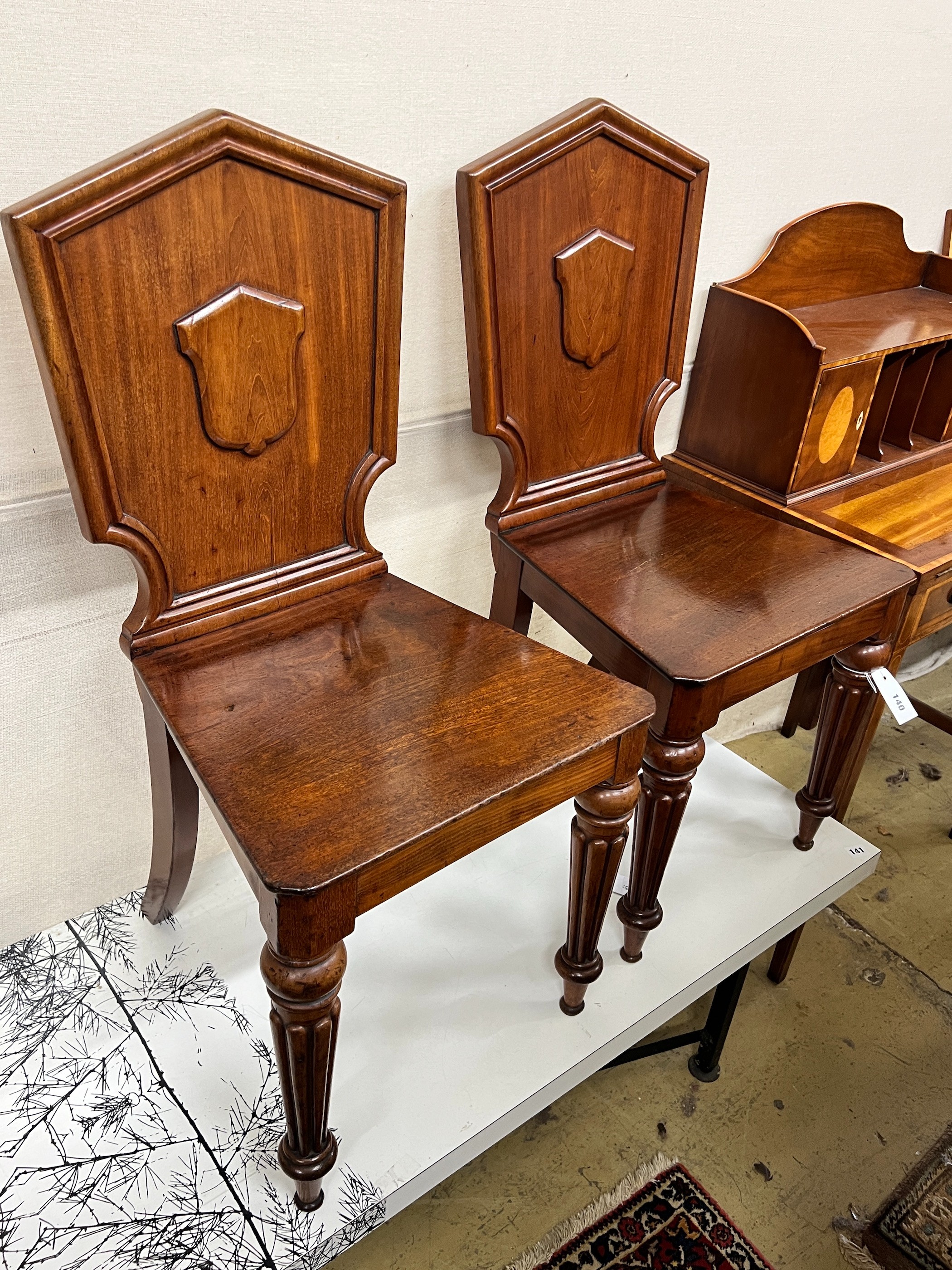 A pair of Victorian mahogany hall chairs